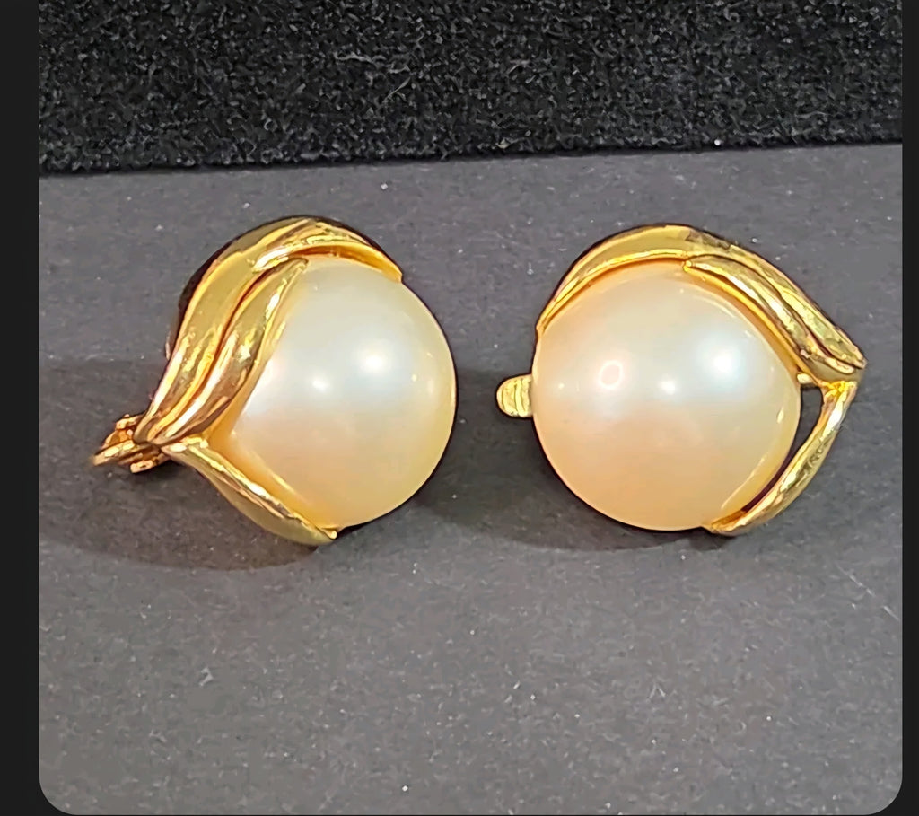 Oddly Darling Vintage Trifari clip-on earrings featuring a large faux pearl set in polished gold-tone leaf metalwork.