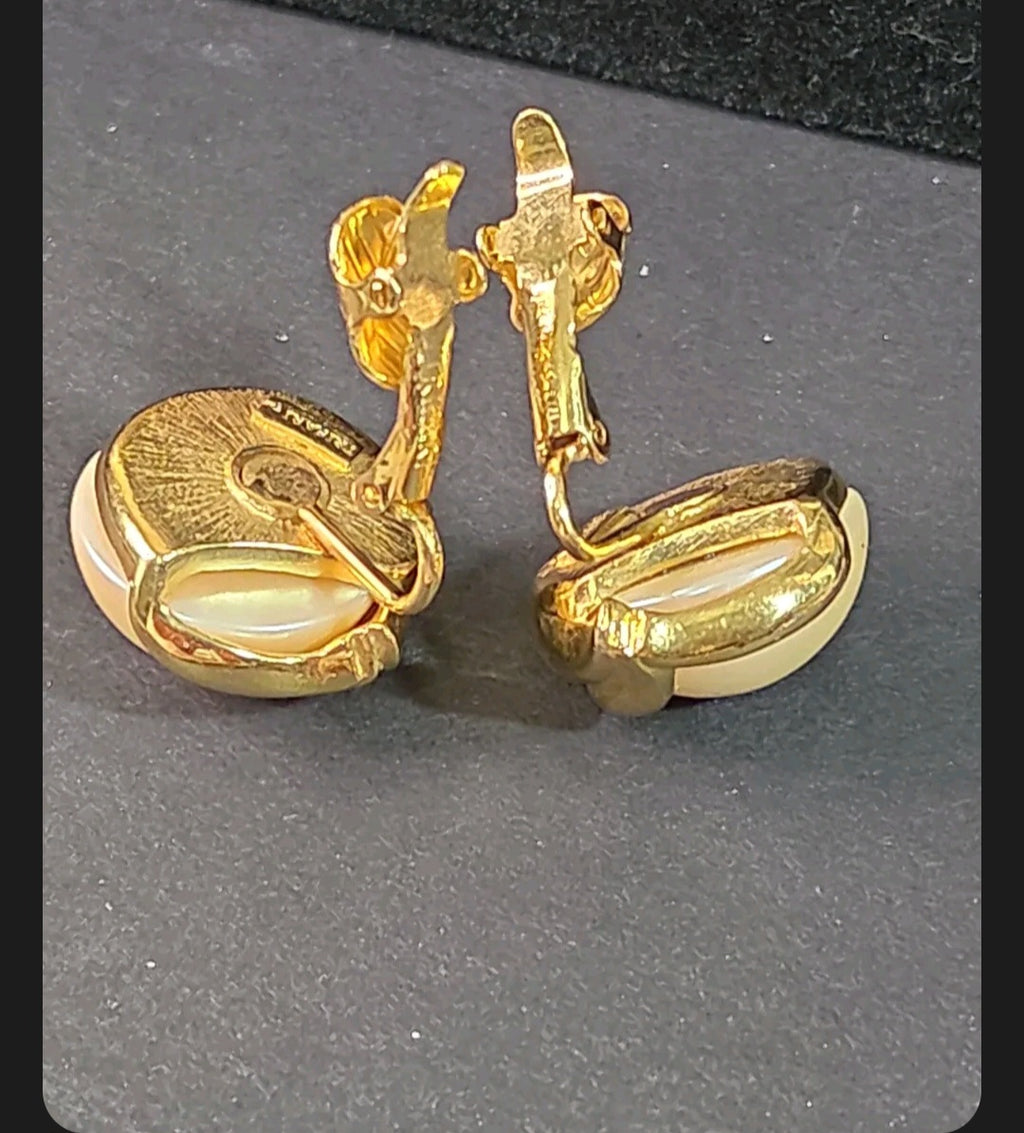 Oddly Darling Vintage Trifari clip-on earrings featuring lustrous faux pearls in a polished gold-tone leaf setting.