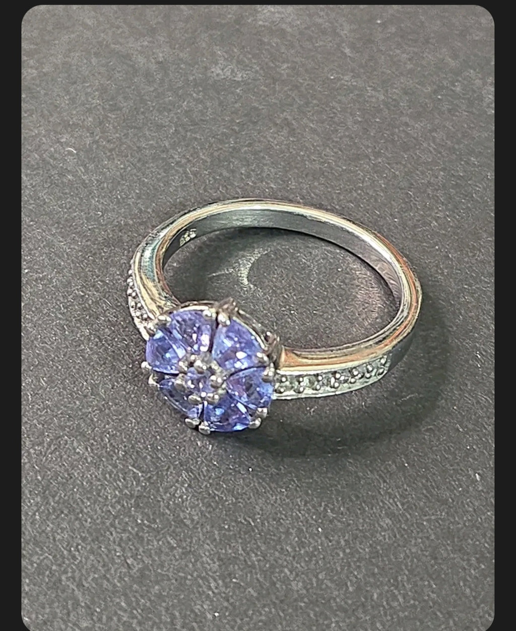 Oddly Darling Vintage floral cluster ring featuring violet gemstones and accent stones on a silver band.