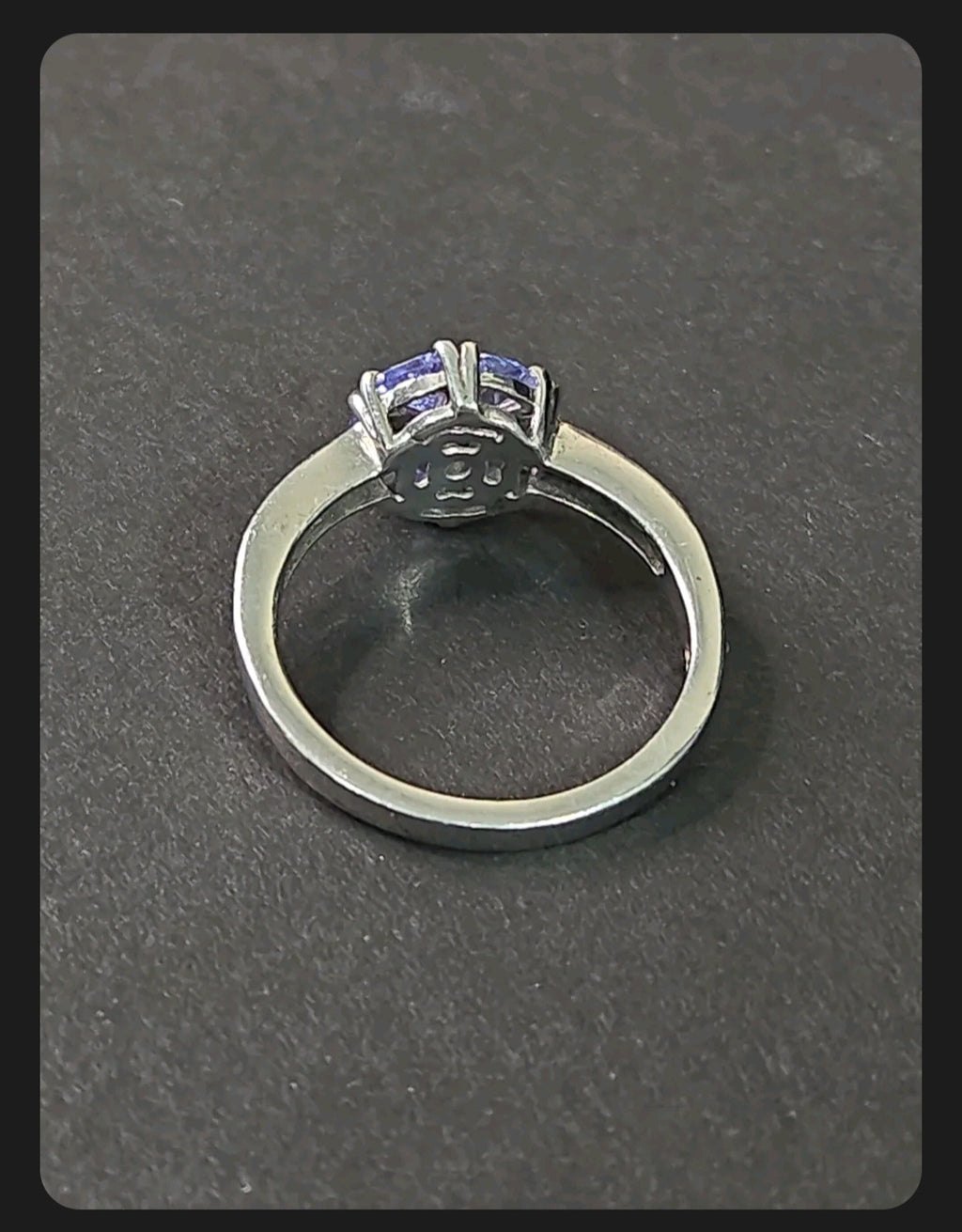 Oddly Darling Vintage floral cluster ring featuring a violet gemstone set in a polished silver band, back view.