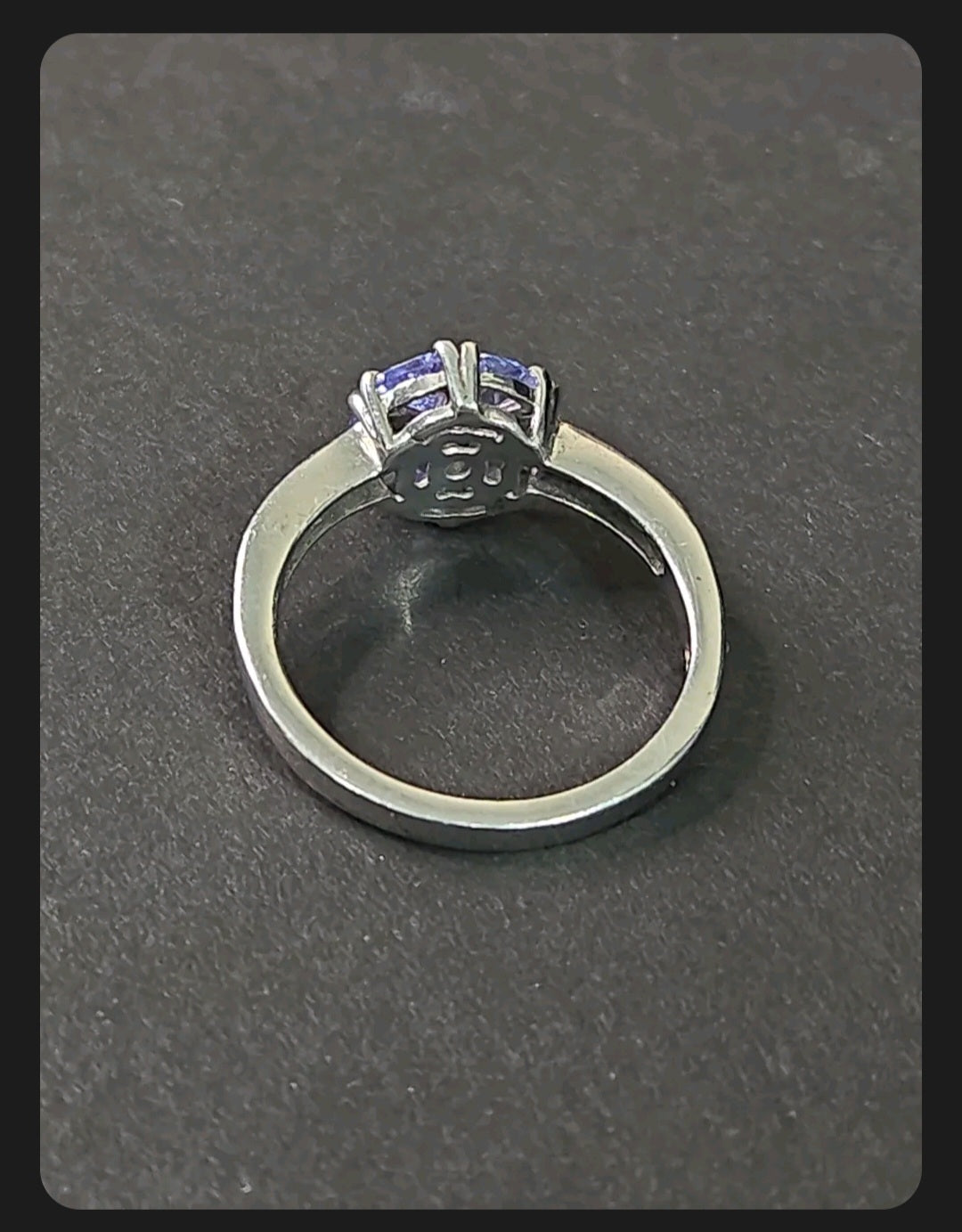 Oddly Darling Vintage floral cluster ring featuring a violet gemstone set in a polished silver band, back view.