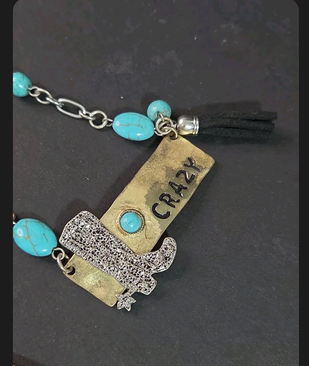 Oddly Darling Vintage western statement necklace with a silver cowboy boot, brass CRAZY plate, and turquoise beads.