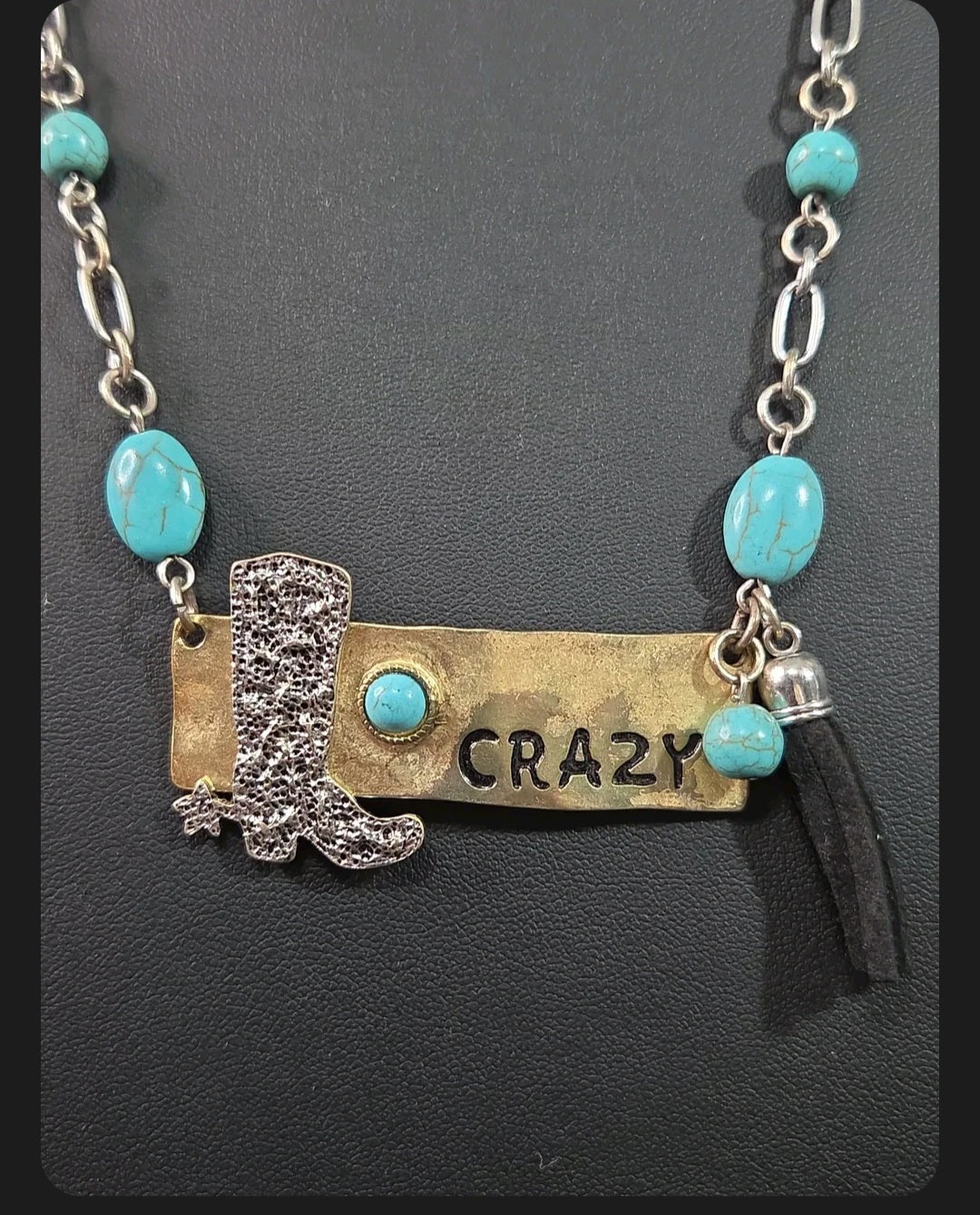 Oddly Darling Vintage western statement necklace featuring a silver cowboy boot, CRAZY brass plate, and turquoise beads.