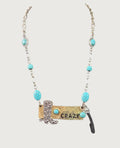 Oddly Darling Vintage western statement necklace with a cowboy boot charm, CRAZY brass plate, and turquoise beads.